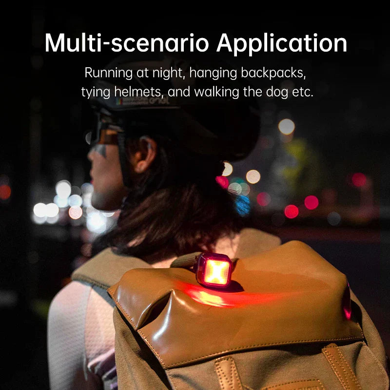 Smart bike tail light attached to backpack for multi-scenario use at night.