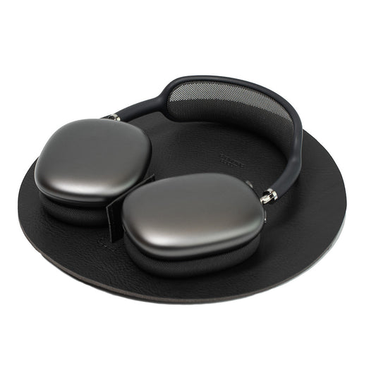 AirPods Max Rest Station in black full-grain leather – side angle view on desk.