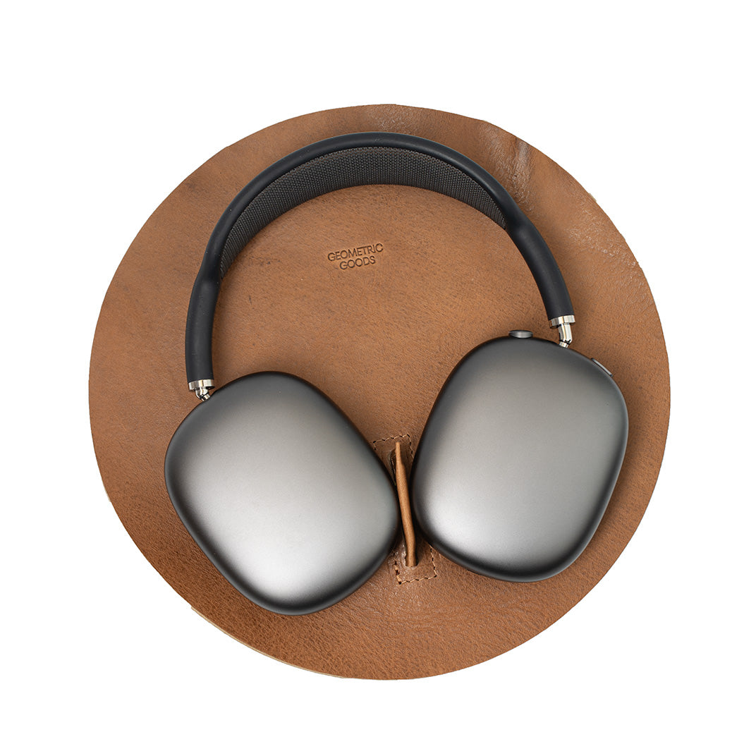 AirPods Max Rest Station in rich tan leather – premium headphone stand with low power mode activation.