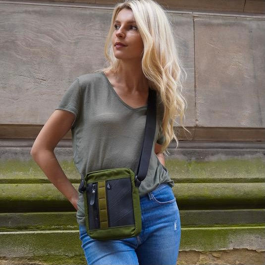 Handmade vegan crossbody reporter bag with upcycled rubber and reclaimed canvas, eco-friendly fashion accessory.