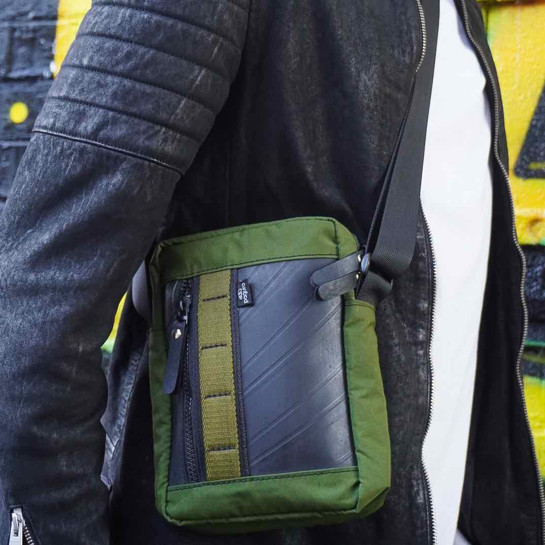 Unisex eco-friendly crossbody bag made from recycled rubber and canvas, sustainable streetwear accessory.