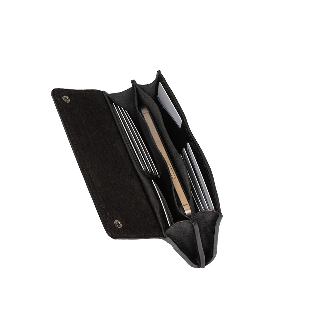 Black leather AirTag wallet open with iPhone and cards inside, multiple compartments visible.